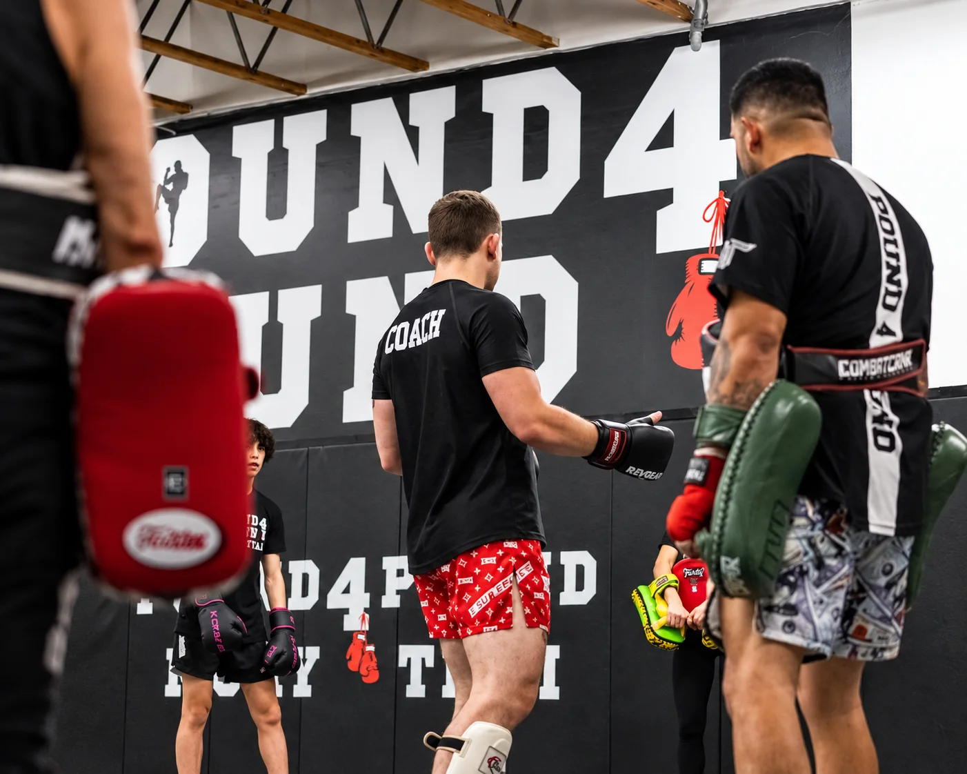 Pound 4 Pound Muay Thai coach leading students during striking training at the gym in Littleton, Colorado