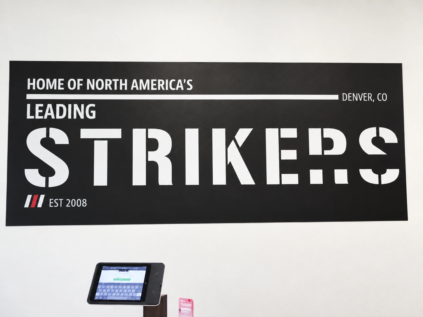 Pound 4 Pound gym wall displaying the Home of North America's Leading Strikers sign in Littleton, Colorado