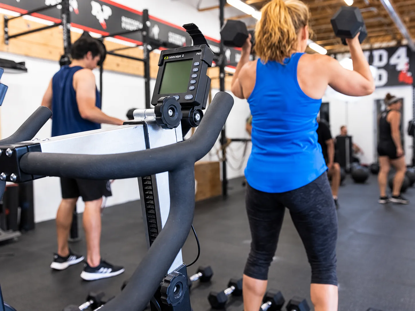Strength and conditioning workout with Concept2 equipment and dumbbell training at Pound 4 Pound in Littleton