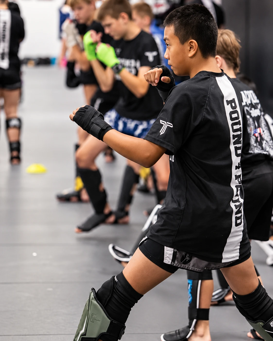 Youth Muay Thai student practicing stance and technique during class at Pound 4 Pound in Littleton, Colorado
